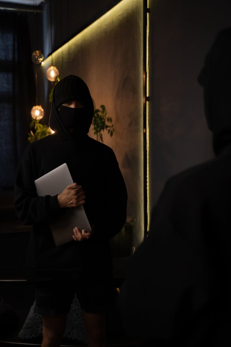 Man in Black Long Sleeve Shirt Holding a Laptop, home insurance